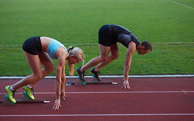 Image showing athlete woman group  running on athletics race track