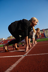 Image showing business people running on racing track