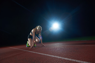 Image showing woman  sprinter leaving starting blocks