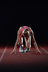 Image showing woman  sprinter leaving starting blocks