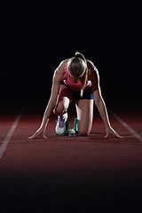 Image showing woman  sprinter leaving starting blocks