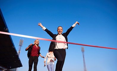 Image showing business people running on racing track