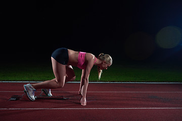 Image showing woman  sprinter leaving starting blocks