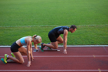 Image showing athlete woman group  running on athletics race track