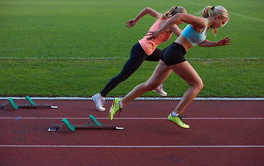 Image showing woman  sprinter leaving starting blocks