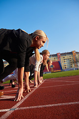 Image showing business people running on racing track