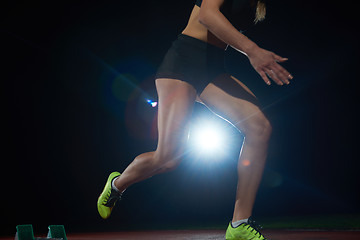 Image showing woman  sprinter leaving starting blocks