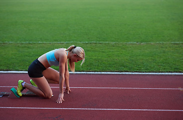 Image showing athlete woman group  running on athletics race track