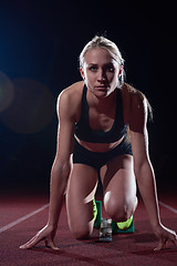 Image showing woman  sprinter leaving starting blocks