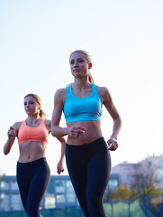 Image showing athlete woman group  running on athletics race track