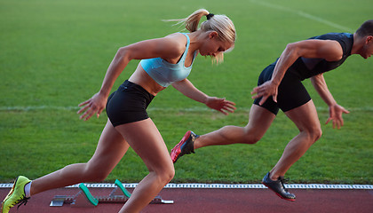 Image showing athlete woman group  running on athletics race track