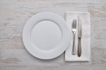 Image showing Plate, cutlery and cloth on wood