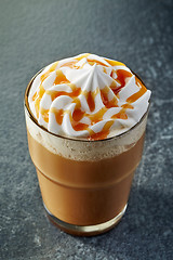 Image showing glass of caramel latte with whipped cream