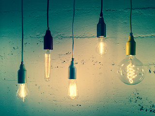 Image showing Illuminated light bulbs on green background