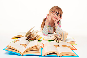 Image showing Little girl sitting on floor with a lot of books