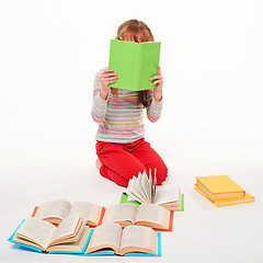 Image showing Little girl sitting on floor with a lot of books