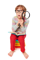 Image showing Little girl sitting on floor with a lot of books