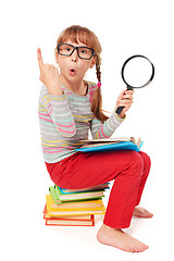 Image showing Little girl sitting on floor with a lot of books