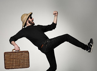 Image showing Young, attractive man  in sunglasses with  suitcase ready to travel 