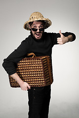 Image showing Young, attractive man  in sunglasses with  suitcase ready to travel 