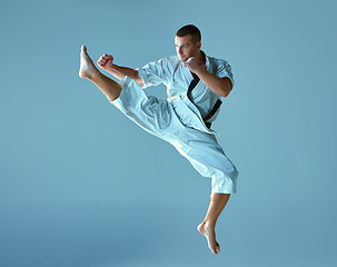 Image showing Man in white kimono training karate