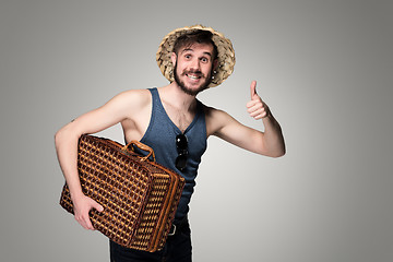 Image showing Young, attractive man  in sunglasses with  suitcase ready to travel 