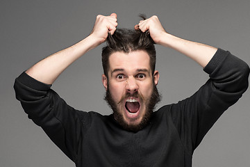 Image showing frustration, man tearing hair out in anger