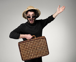 Image showing Young, attractive man  in sunglasses with  suitcase ready to travel 