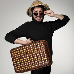 Image showing Young, attractive man  in sunglasses with  suitcase ready to travel 