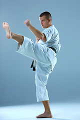 Image showing Man in white kimono training karate