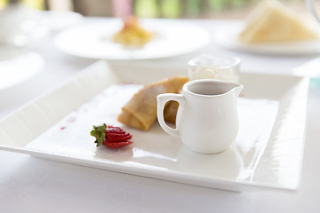 Image showing close up of pancakes and honey or jam on plate