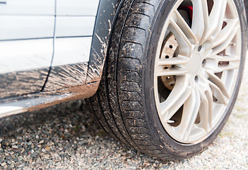 Image showing close up of dirty car wheel on ground