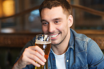 Image showing happy man drinking beer at bar or pub