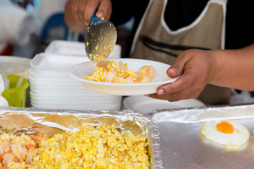 Image showing close up of hands with wok at street market