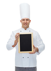 Image showing happy male chef cook holding blank menu board