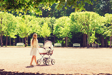 Image showing happy mother with stroller in park