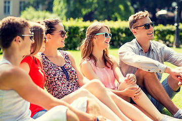 Image showing group of smiling friends outdoors sitting on grass