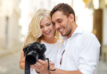 Image showing smiling couple with photo camera