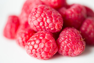 Image showing juicy fresh ripe red raspberries on white