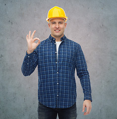 Image showing smiling male builder in helmet showing ok sign