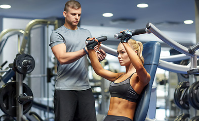 Image showing man and woman flexing muscles on gym machine