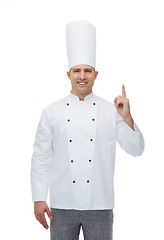 Image showing happy male chef cook pointing finger up