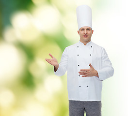 Image showing happy male chef cook inviting