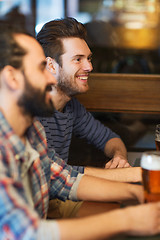 Image showing happy male friends drinking beer at bar or pub