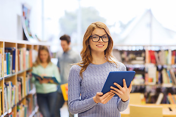 Image showing happy student girl with tablet pc in library