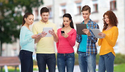 Image showing group of teenagers with smartphones and tablet pc