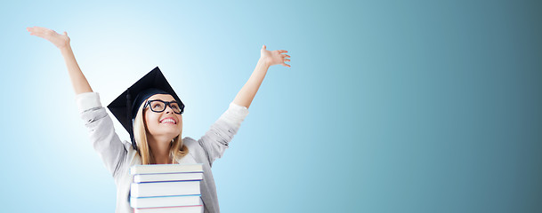 Image showing happy student in mortar board cap with books