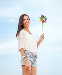 Image showing girl with windmill toy on the beach