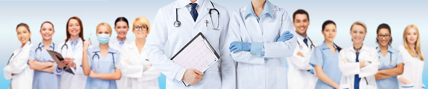 Image showing nurse and male doctor holding cardiogram