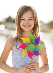 Image showing happy girl with colorful pinwheel toy